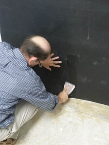 Using your hands and a putty knife, smooth out all the air bubbles from behind the BLockaid® so that you get a good bond when the adhesive cures.