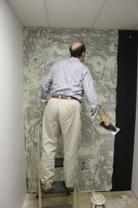 2. Well, when you get tired, make your friend finish troweling out the adhesive to cover where the panel is going. (You are going to overlap the seams.) 