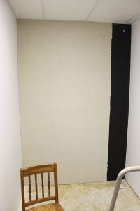 3. Starting at the top, hang the Sound Channels® overlapping the seam of the BlockAid under it. Smooth out the air bubbles with your hands. Make sure it lines up well. No screws needed!